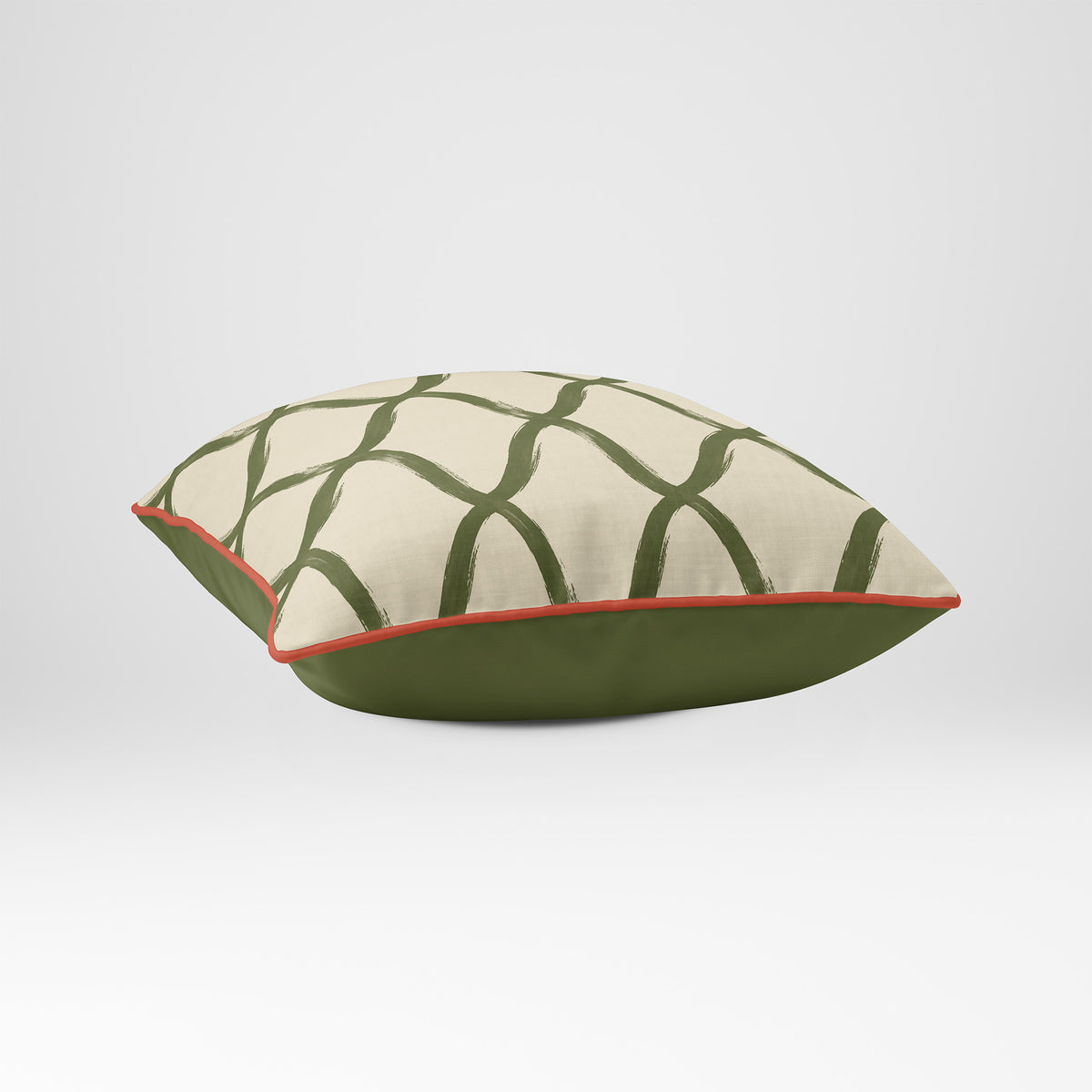 Angled view showing the front and Deep Olive plain reverse of a Palace Trellis square cushion in Olive & Tomato, finished with Tomato piping.