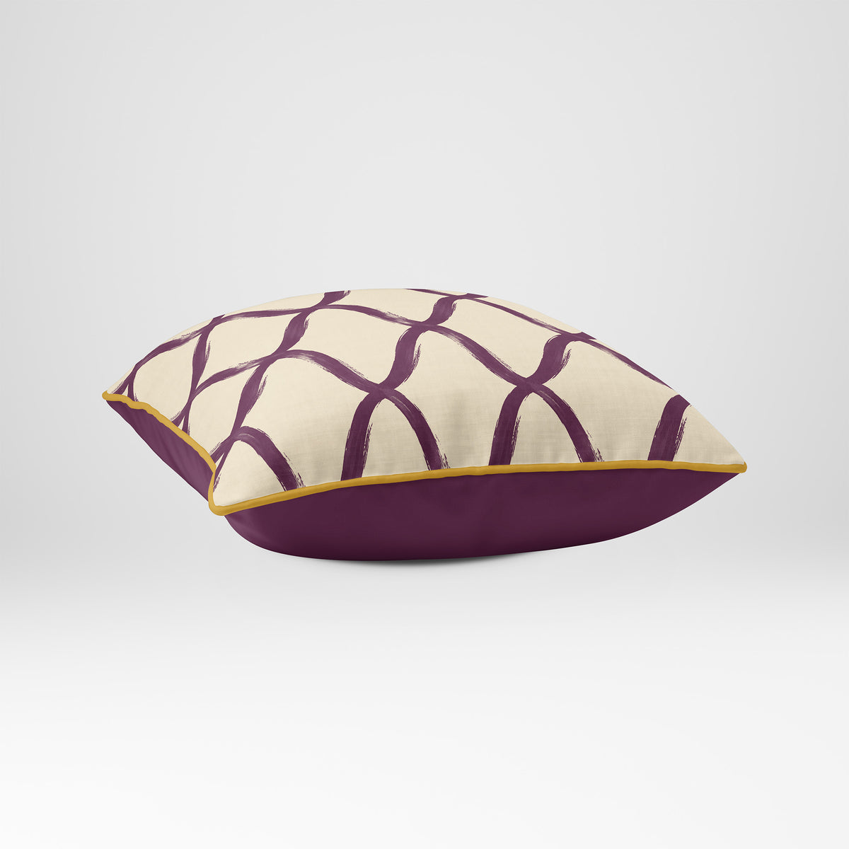 Angled view showing the front and Rich Plum plain reverse of a Palace Trellis square cushion in Plum & Saffron, finished with Saffron piping.
