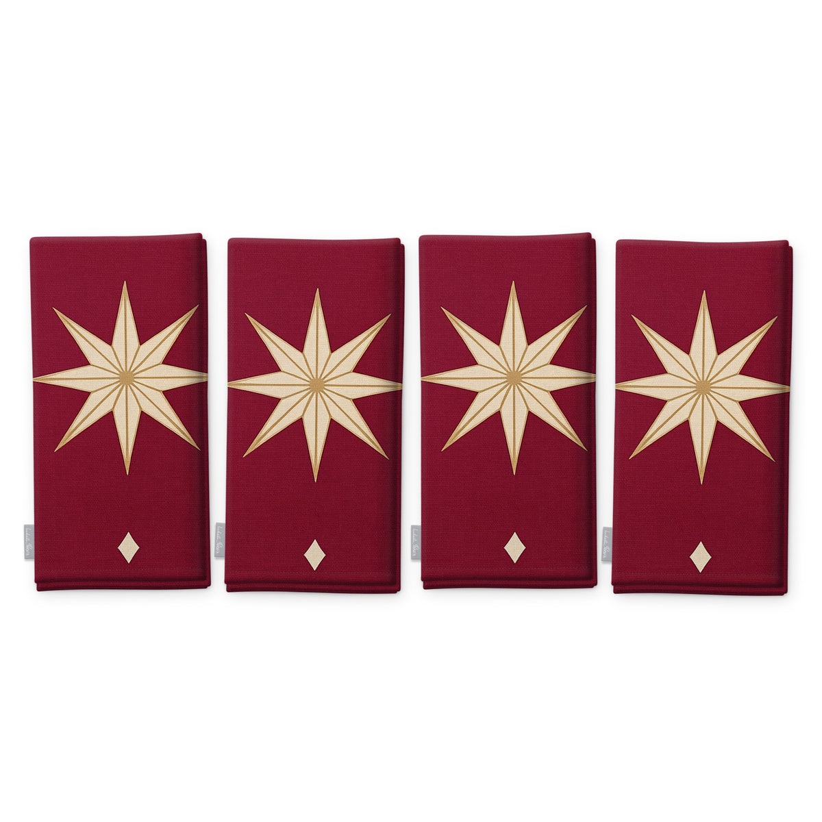 Stars Christmas napkins in burgundy and gold, set of four, folded on white, showing the same large gold eight-pointed star