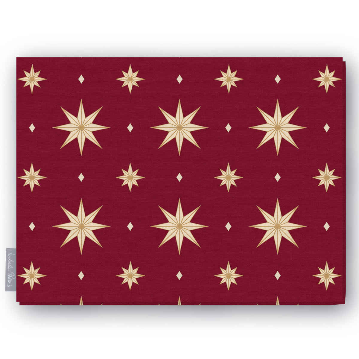 Stars Christmas tablecloth in burgundy and gold, folded on white, showing gold eight-pointed stars