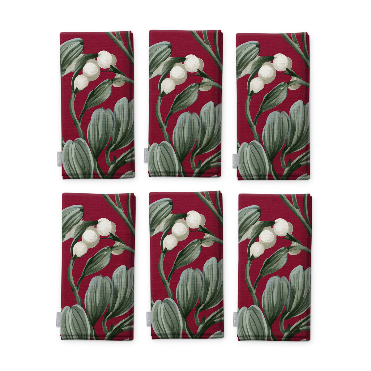 Burgundy Mistletoe Christmas napkins, set of six, folded on white, showing the same sprig of mistletoe with white berries