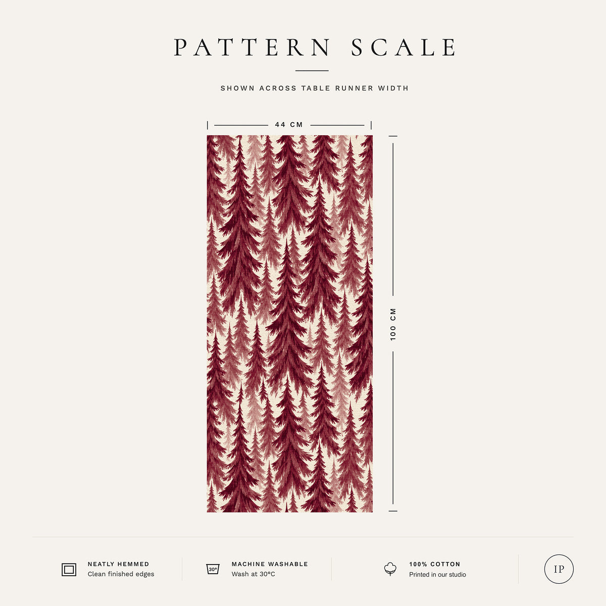 Pattern scale of the Spruce Stand Christmas table runner in burgundy on ivory across its 44 cm width, with care notes