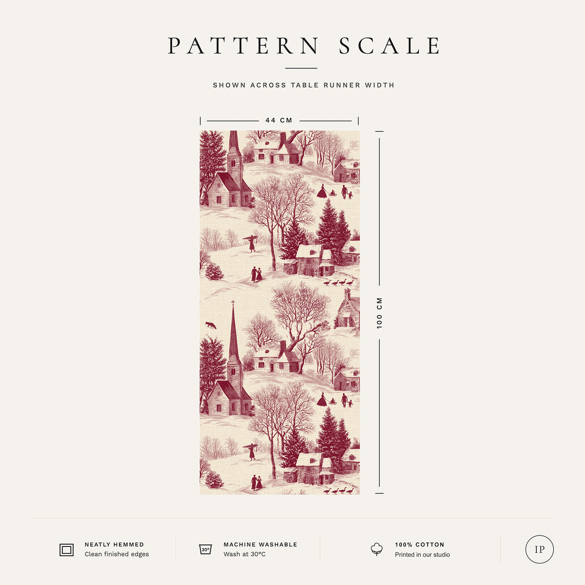 Pattern scale of the Village Toile Christmas table runner in burgundy on ivory across its 44 cm width, with care notes