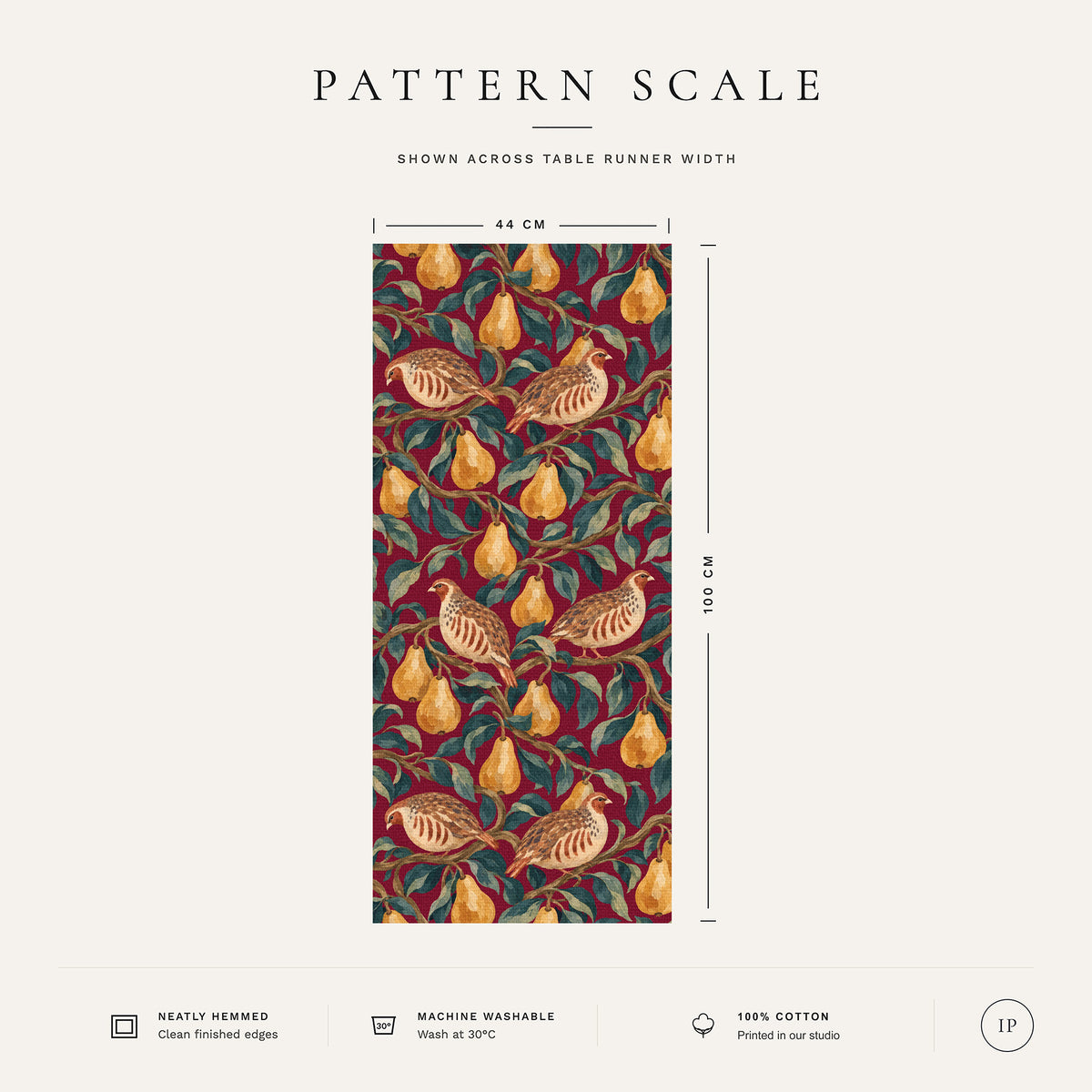 Pattern scale of the Partridge and Pear Christmas table runner in burgundy across its 44 cm width, with care notes
