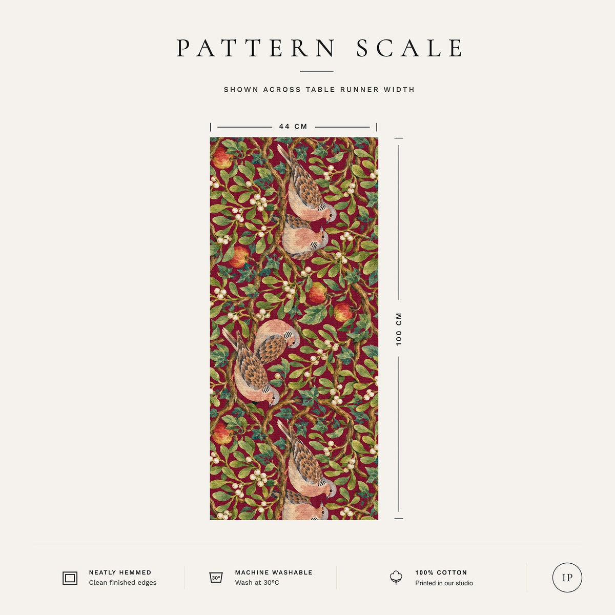 Pattern scale of the Turtle Doves and Mistletoe Christmas table runner in burgundy across its 44 cm width, with care notes