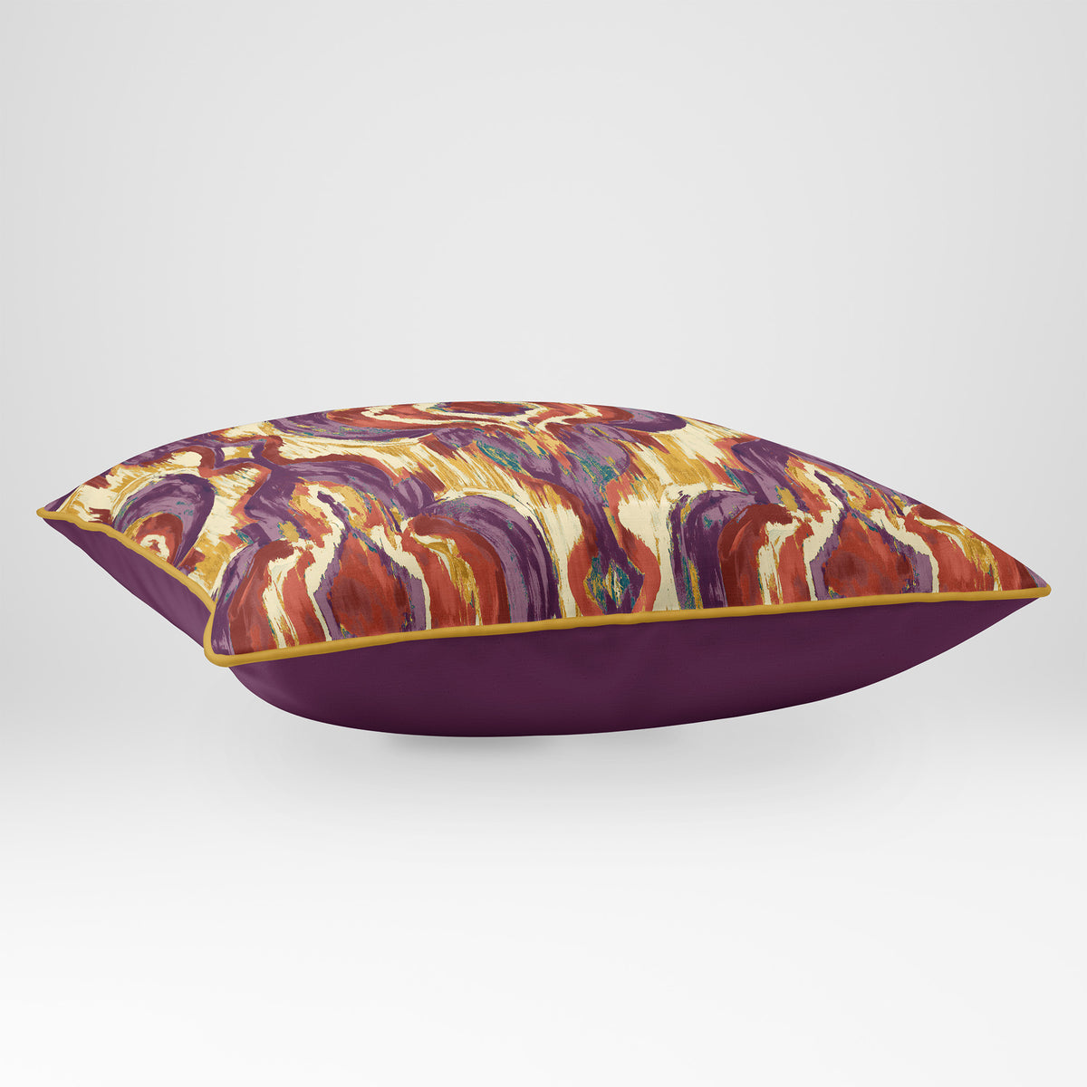 Angled view showing the front and Rich Plum plain reverse of a Court Medallion rectangular cushion in Plum & Saffron, finished with Saffron piping.