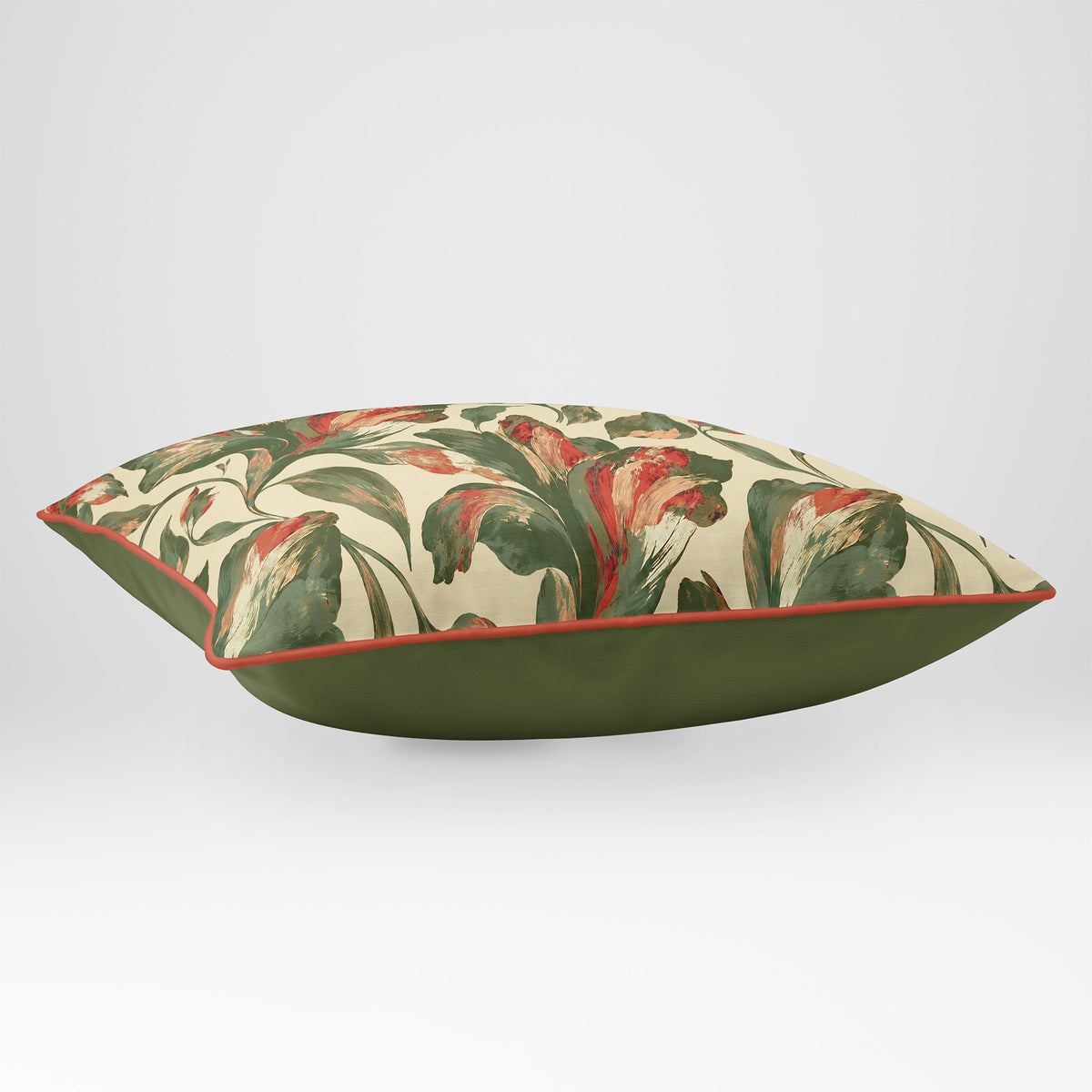 Angled view showing the front and Deep Olive plain reverse of a Fiora Floral rectangular cushion in Olive & Tomato, finished with Tomato piping.