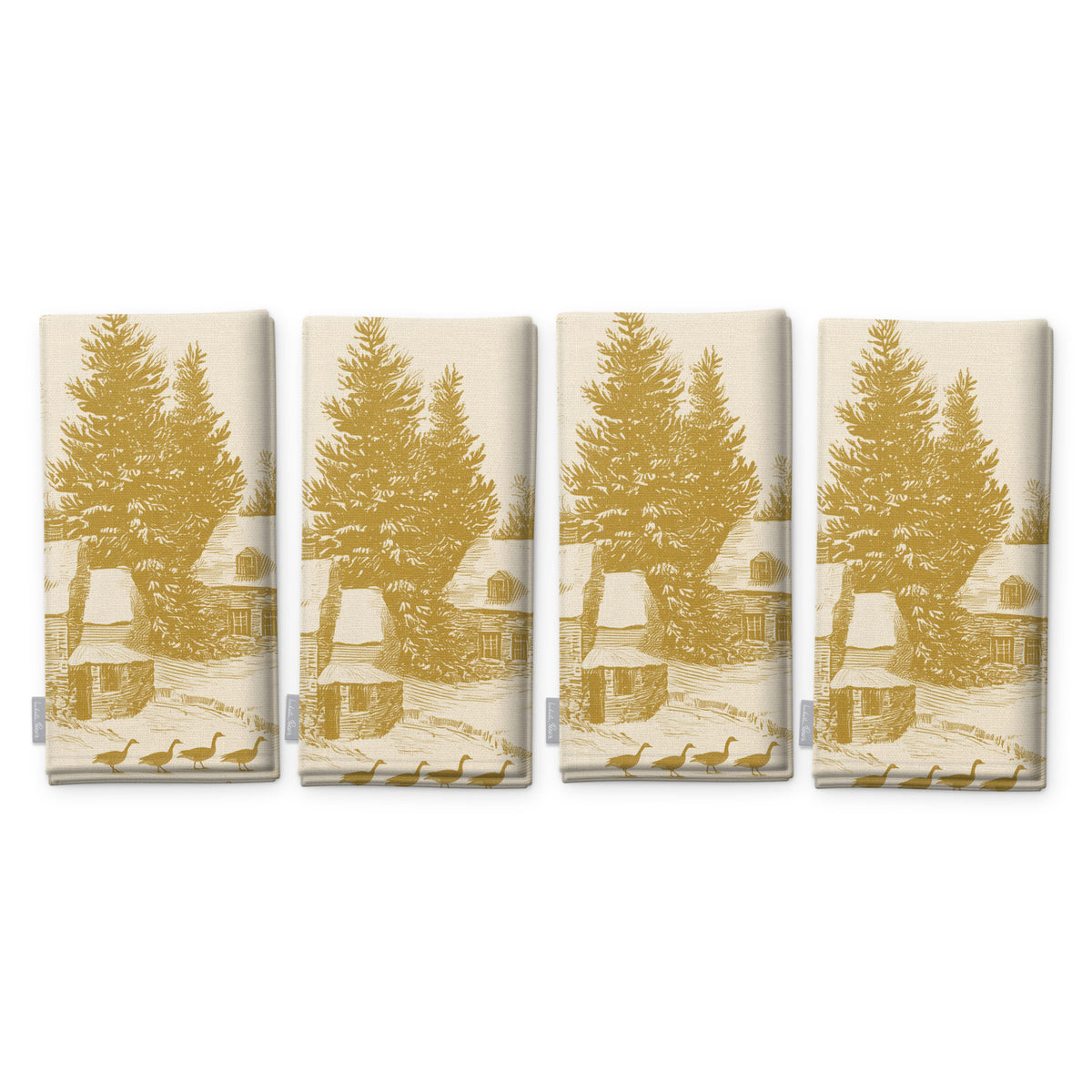 Village Toile Christmas napkins in gold on ivory, set of four, folded on white, showing the same fir tree and snowy cottage