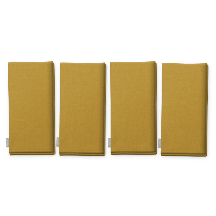 Plain gold cotton Christmas napkins, set of four, folded on white