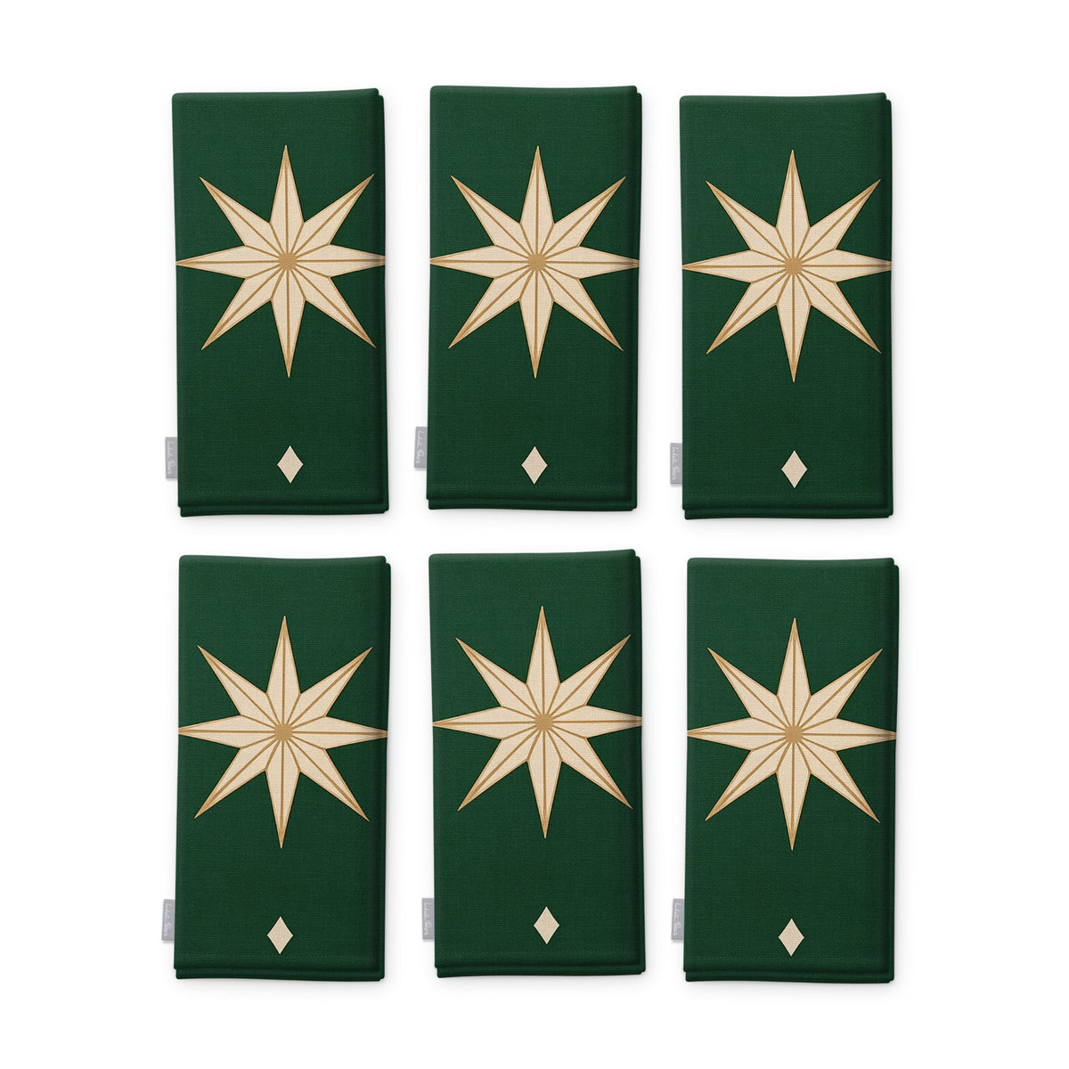 Stars Christmas napkins in green and gold, set of six, folded on white, showing the same large gold eight-pointed star