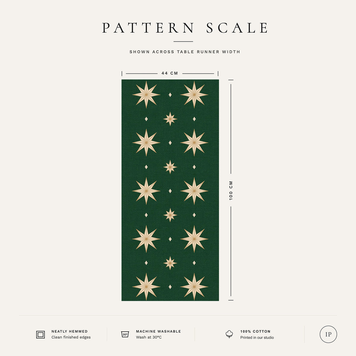 Pattern scale of the Stars Christmas table runner in green and gold across its 44 cm width, with care notes