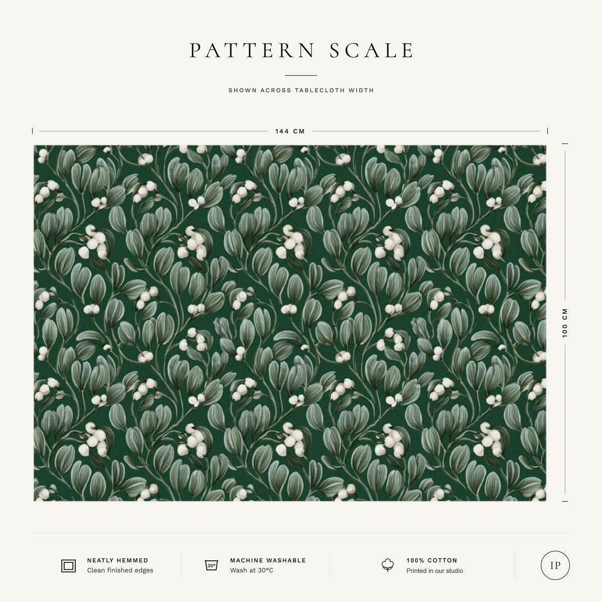 Pattern scale of the Mistletoe Christmas tablecloth in green across its 144 cm width, with care notes