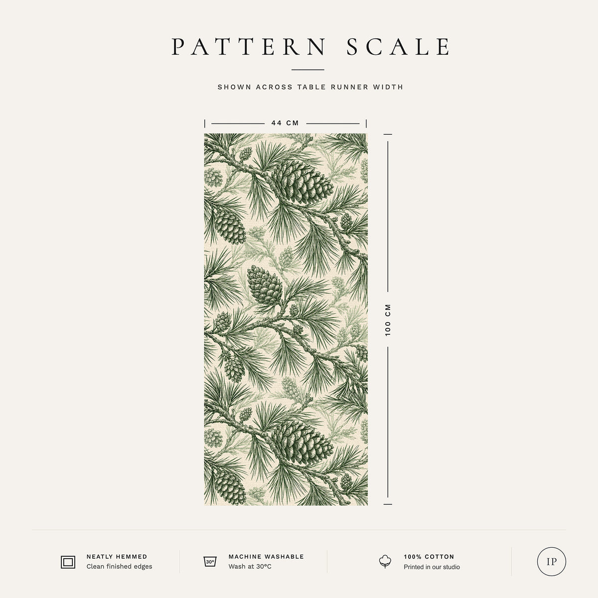 Pattern scale of the Pine Bough Christmas table runner in green on ivory across its 44 cm width, with care notes