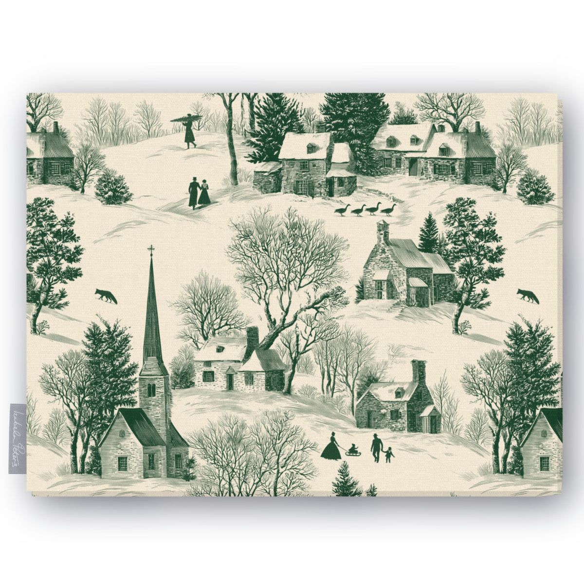 Village Toile Christmas tablecloth in green on ivory, folded on white, showing a snowy village with a church and cottages