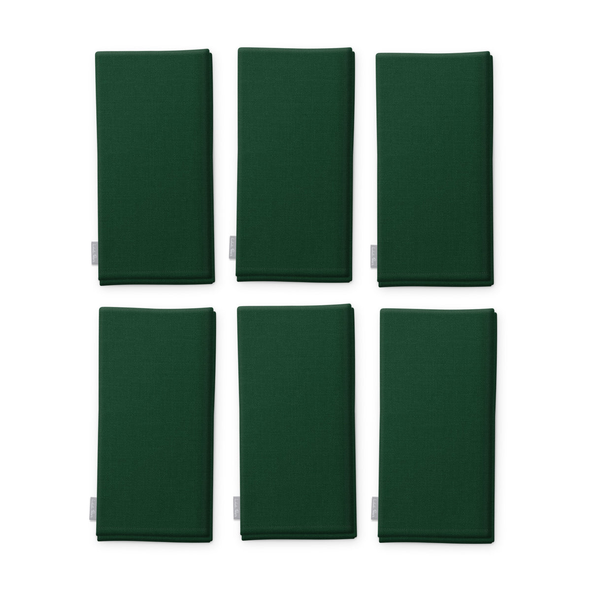 Plain green cotton Christmas napkins, set of six, folded on white