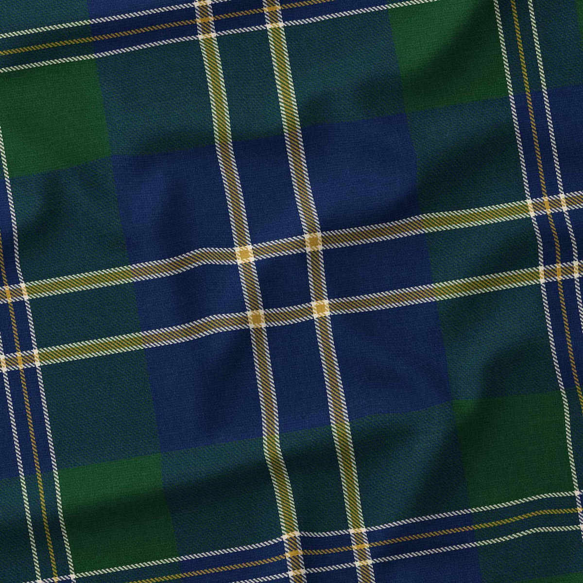 Close-up of the green tartan Christmas tablecloth, showing the green and navy check and fine ivory and gold lines