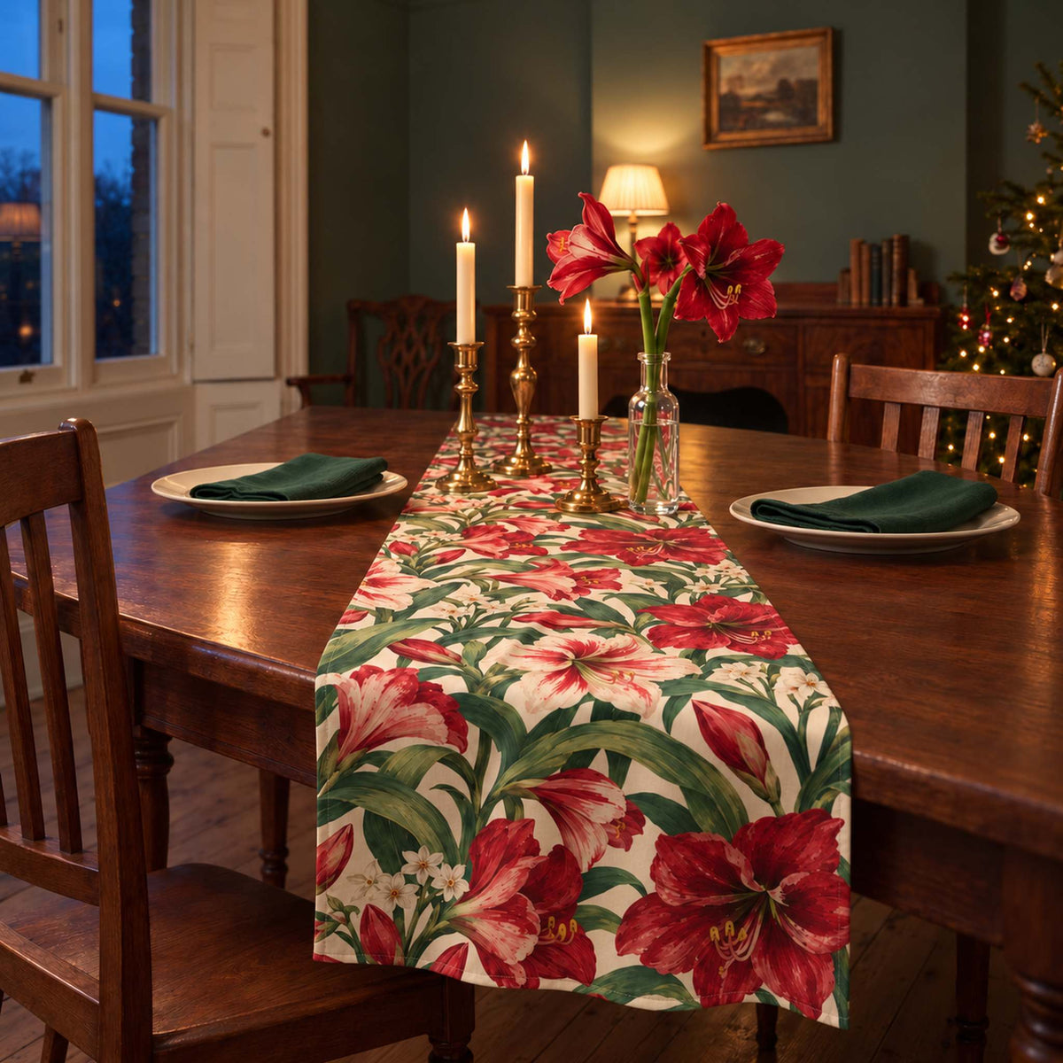 Amaryllis Christmas table runner in Ivory, styled on a wooden table with a softly draped end in a candlelit Christmas room.
