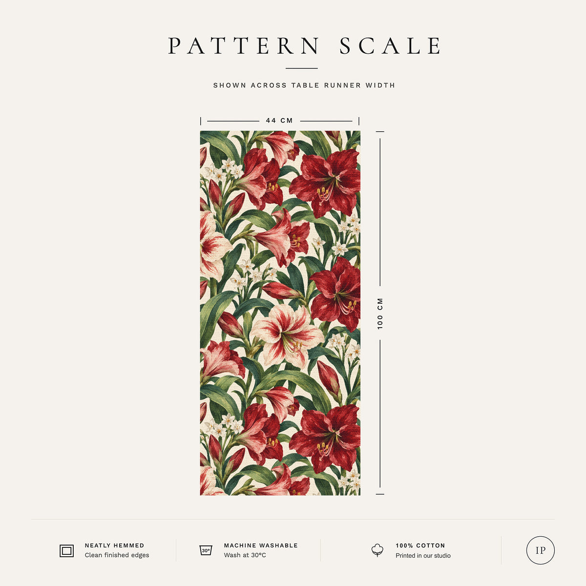 Pattern scale of the Amaryllis Christmas table runner in ivory across its 44 cm width, with care notes