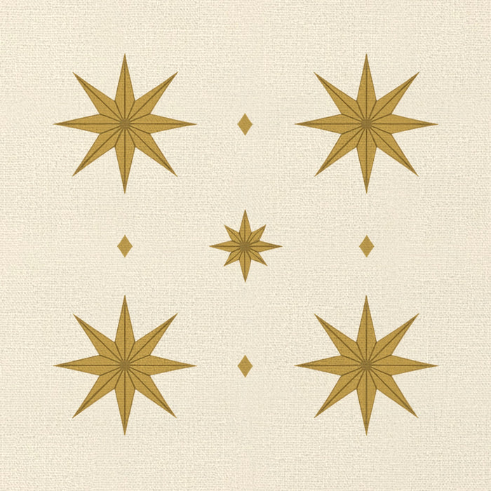 Close-up of the Stars Christmas napkin print in ivory and gold on cotton, showing gold eight-pointed stars