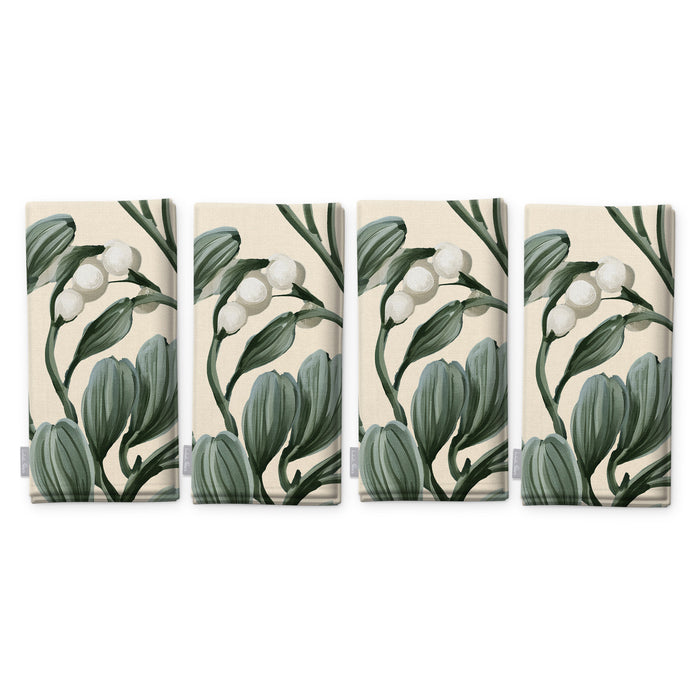 Ivory Mistletoe Christmas napkins, set of four, folded on white, showing the same sprig of mistletoe with white berries