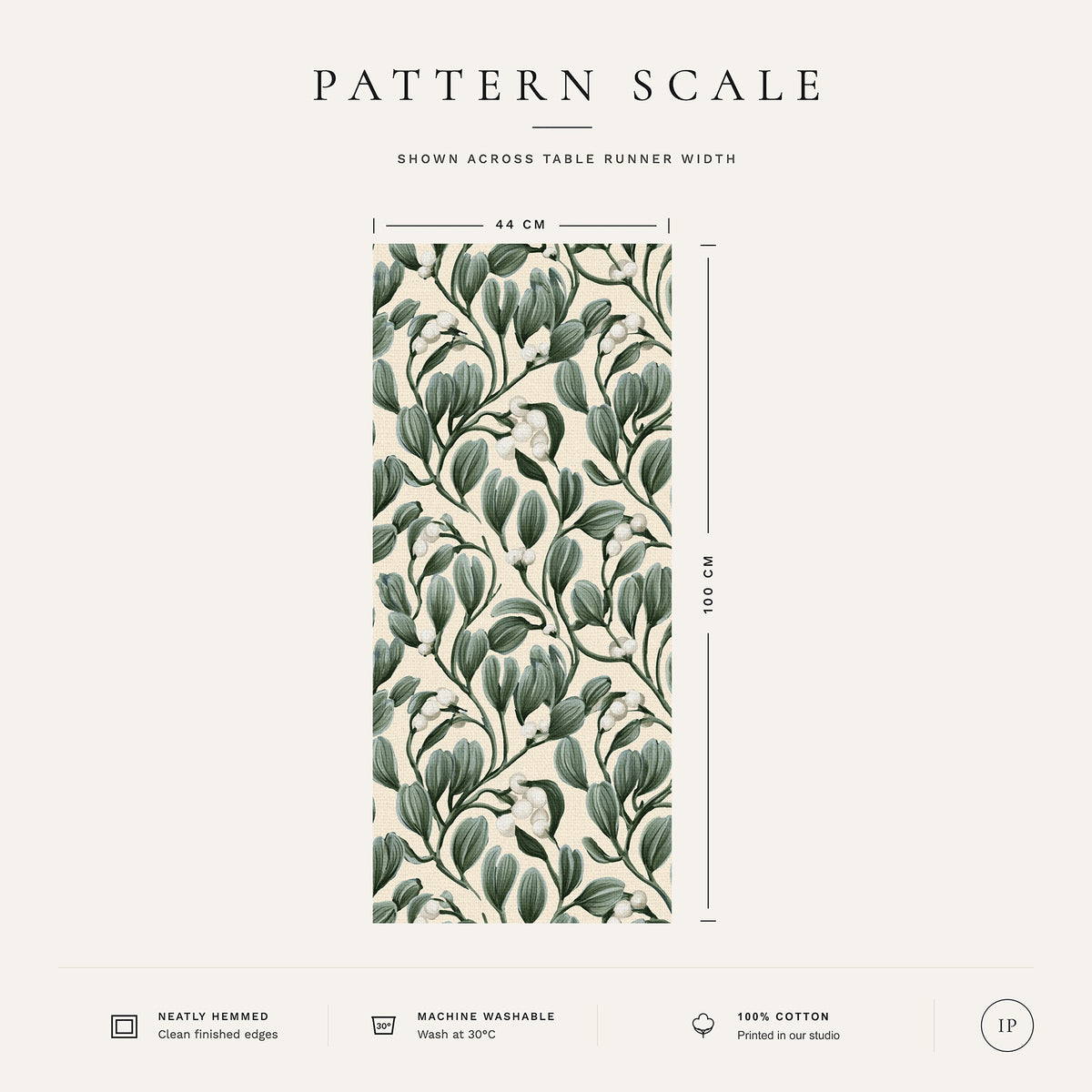 Pattern scale of the Mistletoe Christmas table runner in ivory across its 44 cm width, with care notes