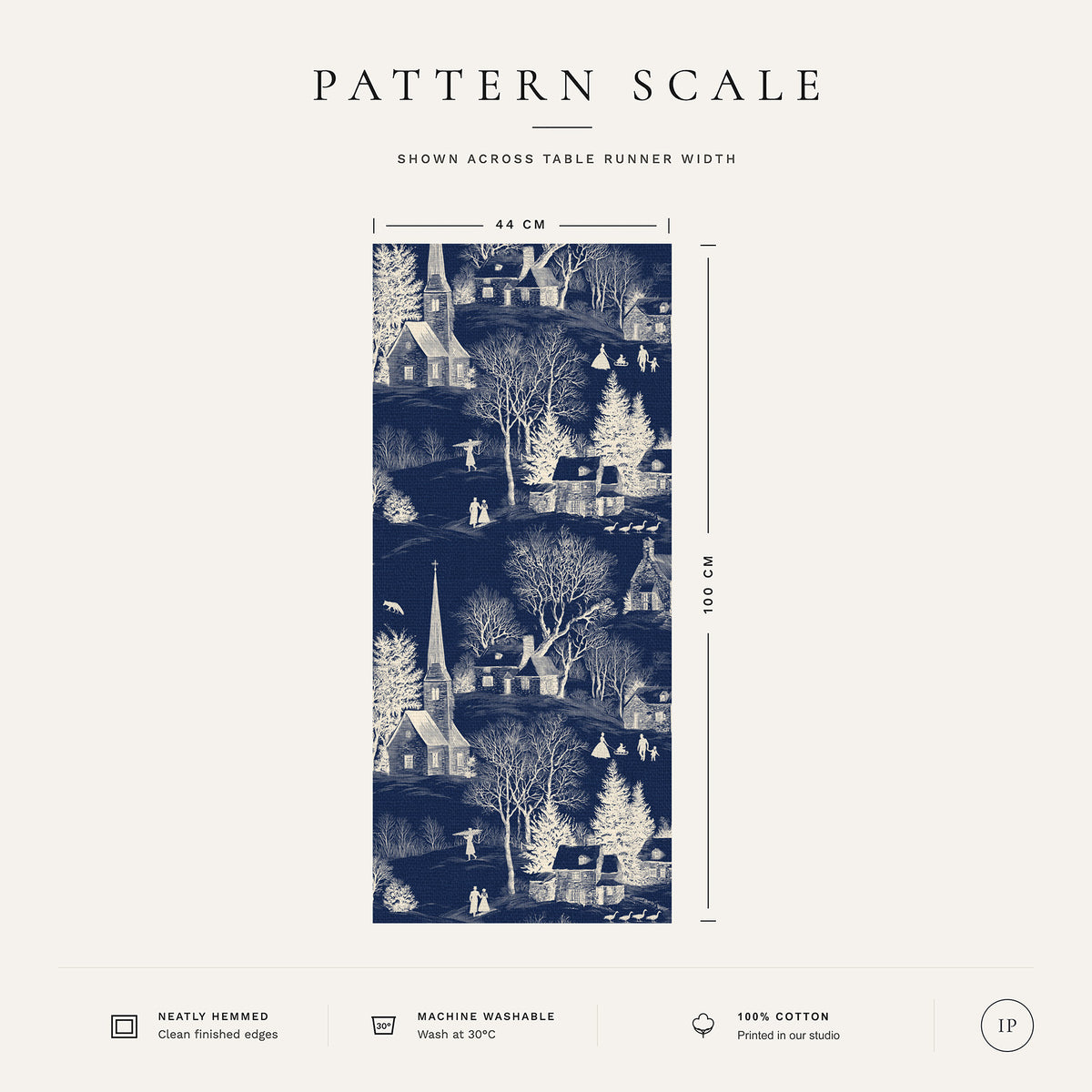 Pattern scale of the Village Toile Christmas table runner in ivory on navy across its 44 cm width, with care notes