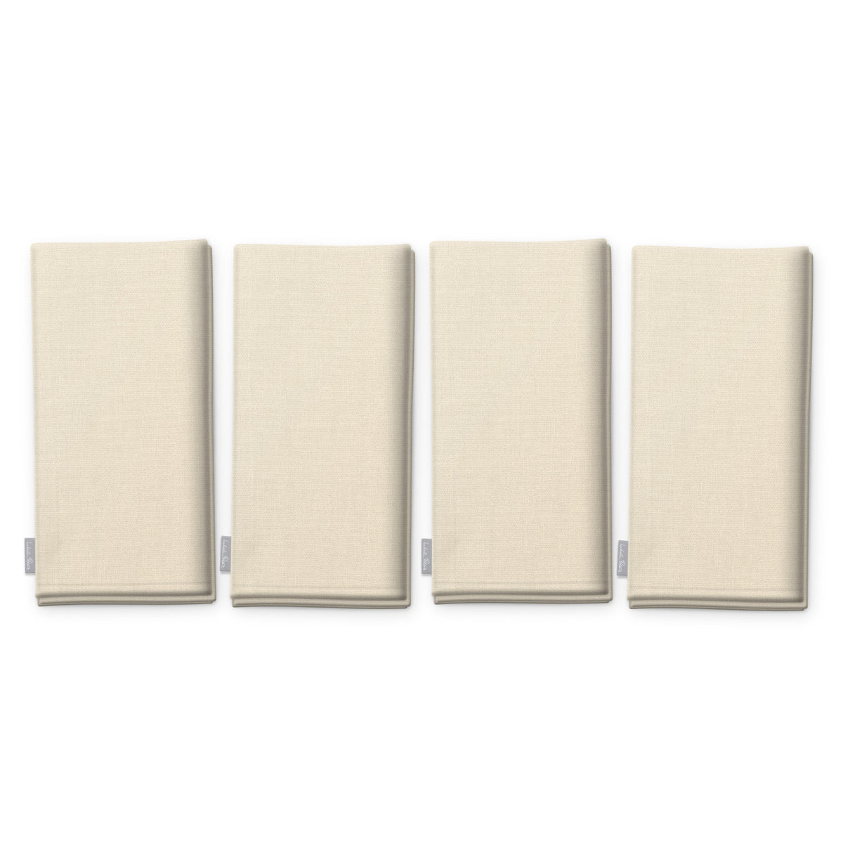Plain ivory cotton Christmas napkins, set of four, folded on white