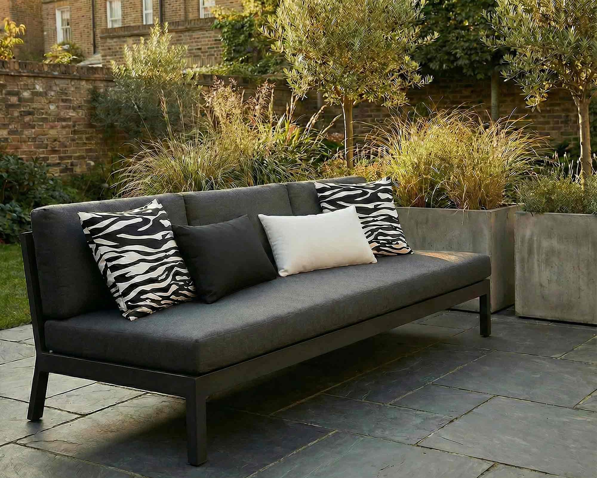 Outdoor cushions styled on a modern garden sofa in a contemporary patio setting