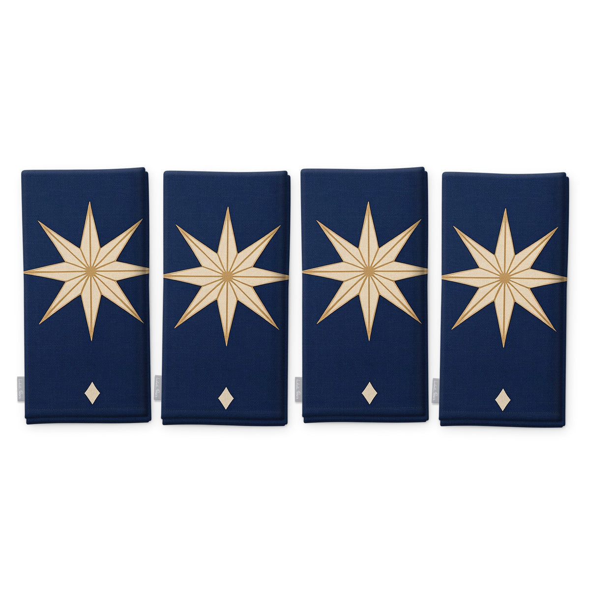 Stars Christmas napkins in navy and gold, set of four, folded on white, showing the same large gold eight-pointed star