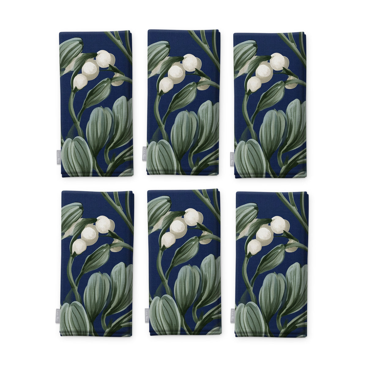 Navy Mistletoe Christmas napkins, set of six, folded on white, showing the same sprig of mistletoe with white berries