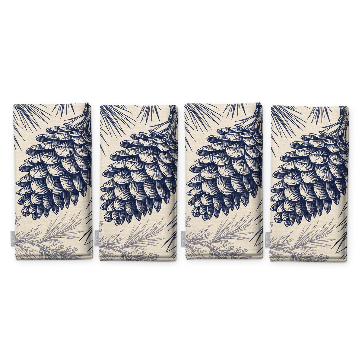 Pine Bough Christmas napkins in navy on ivory, set of four, folded on white, showing the same pine cone on a bough