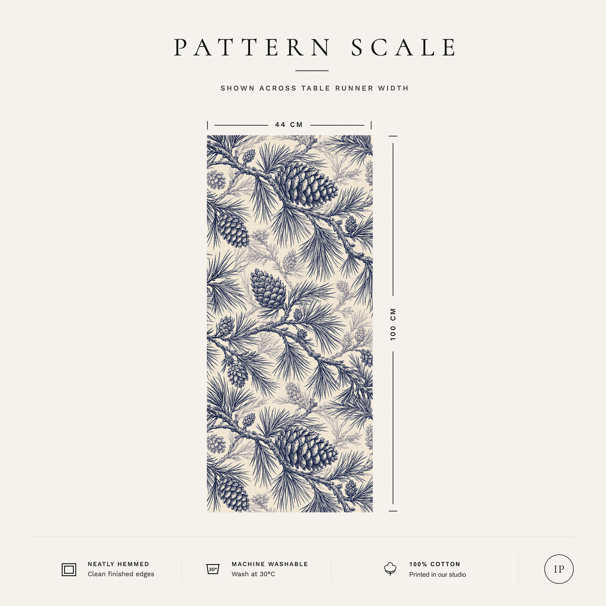 Pattern scale of the Pine Bough Christmas table runner in navy on ivory across its 44 cm width, with care notes
