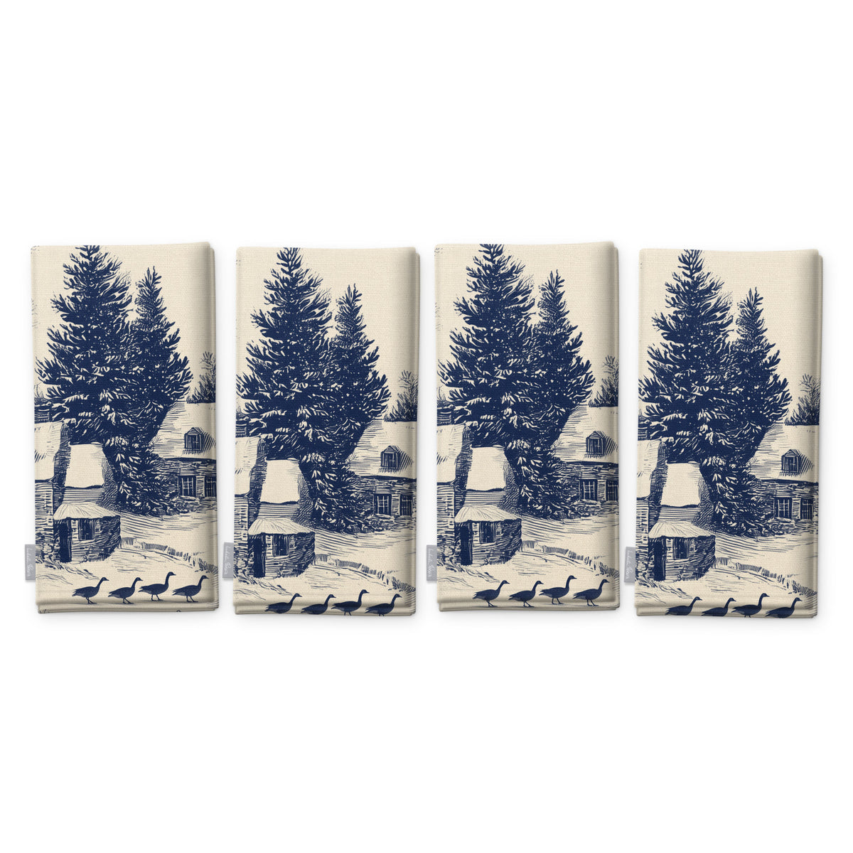Village Toile Christmas napkins in navy on ivory, set of four, folded on white, showing the same fir tree and snowy cottage