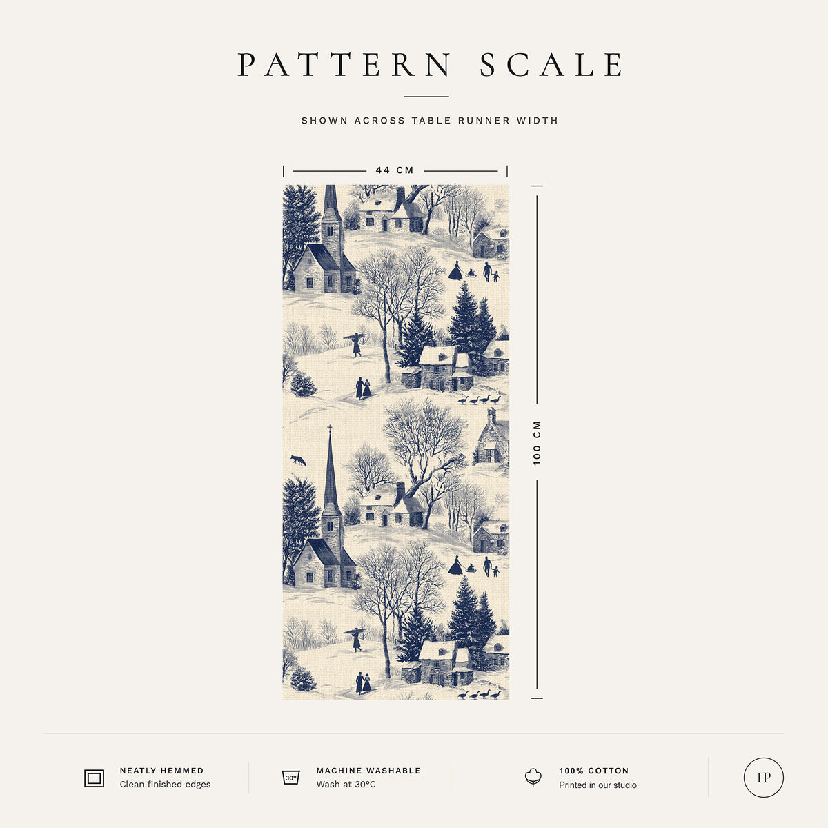 Pattern scale of the Village Toile Christmas table runner in navy on ivory across its 44 cm width, with care notes