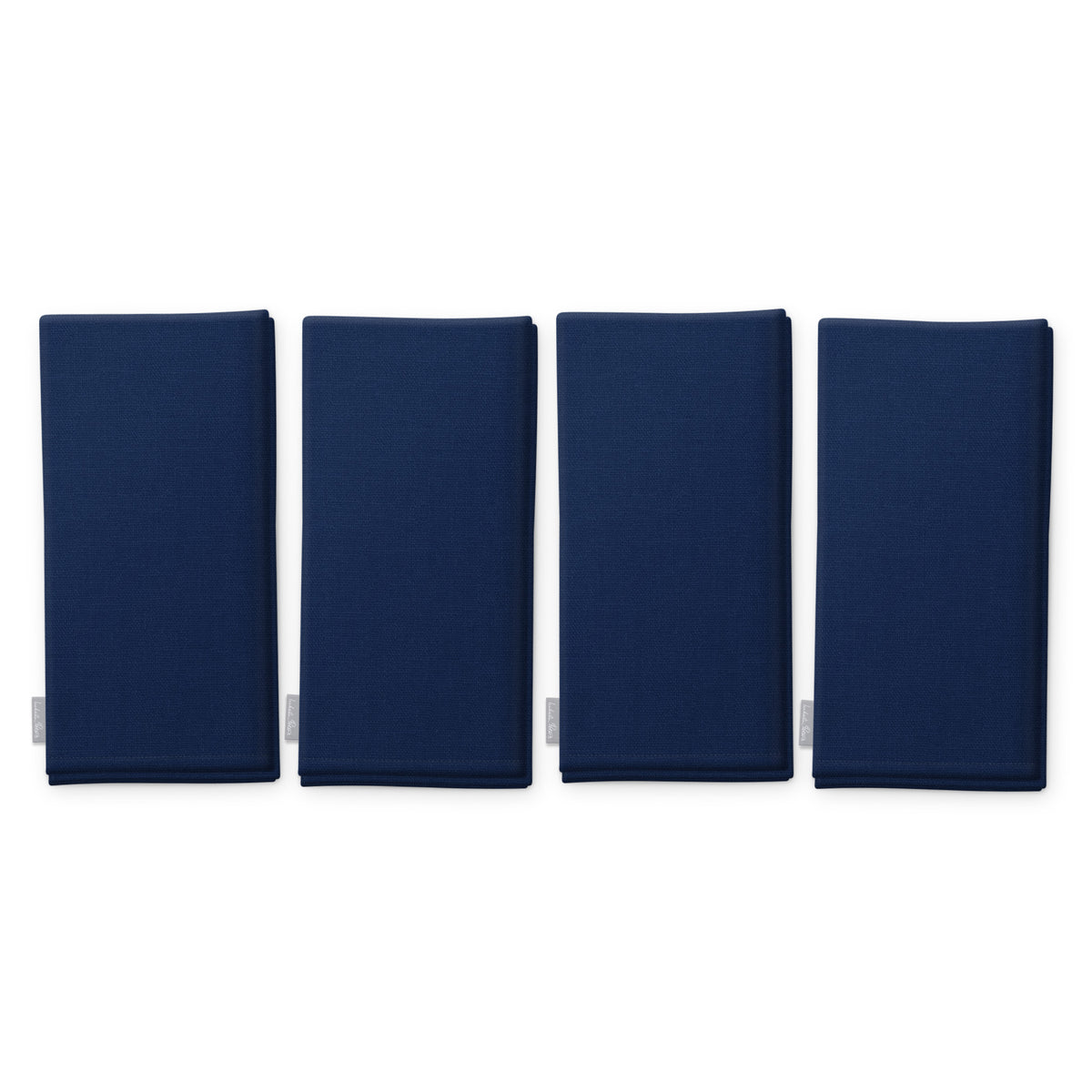 Plain navy cotton Christmas napkins, set of four, folded on white