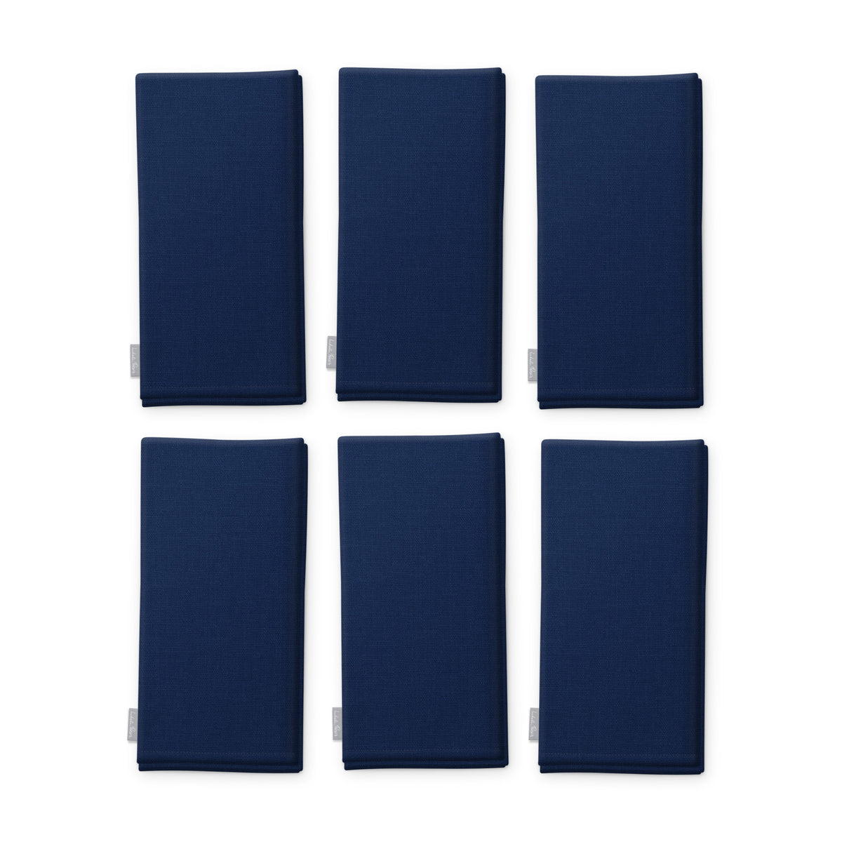 Plain navy cotton Christmas napkins, set of six, folded on white