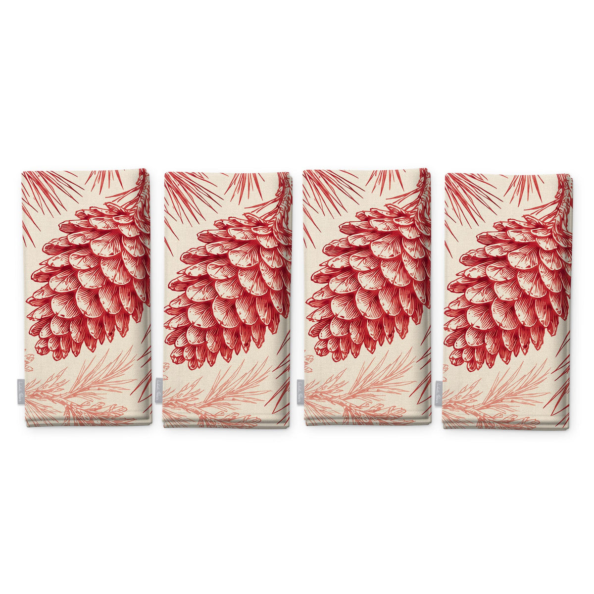 Pine Bough Christmas napkins in red on ivory, set of four, folded on white, showing the same pine cone on a bough