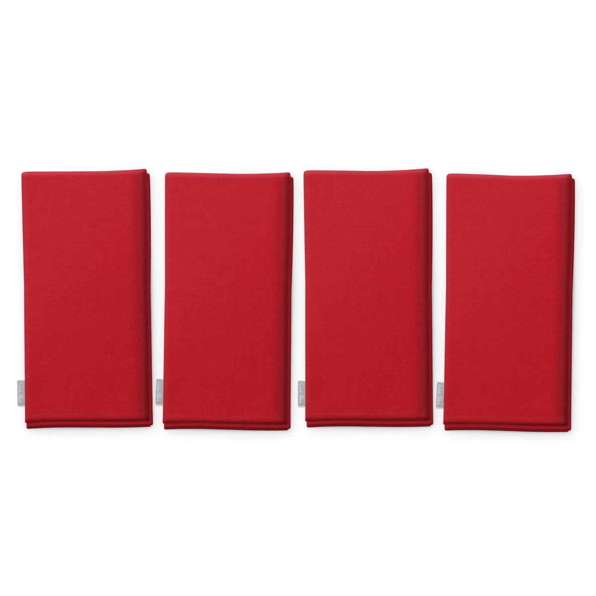 Plain red cotton Christmas napkins, set of four, folded on white