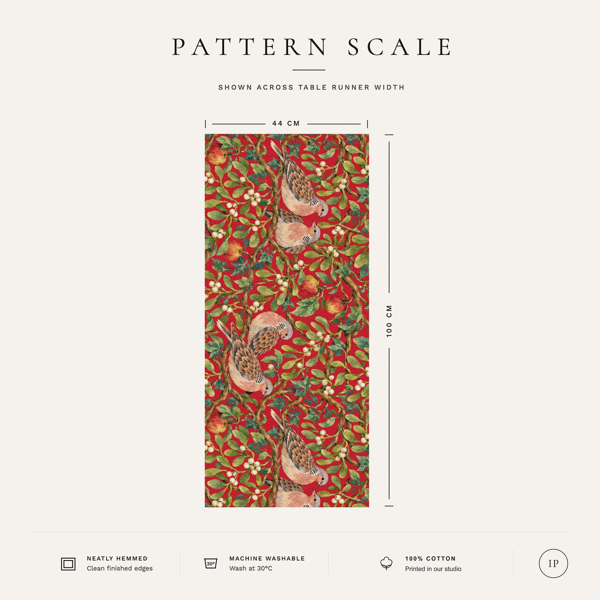 Pattern scale of the Turtle Doves and Mistletoe Christmas table runner in red across its 44 cm width, with care notes