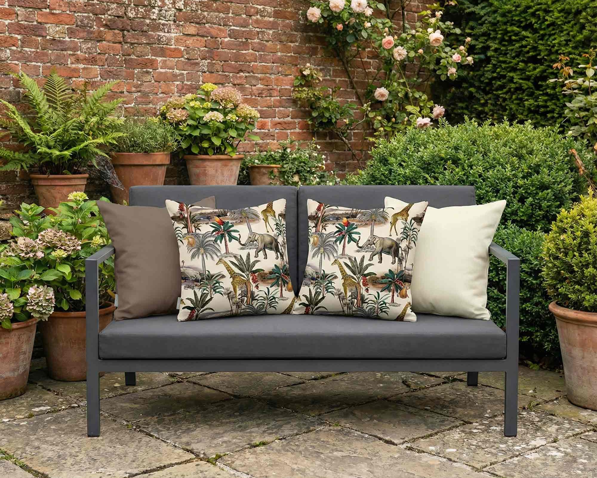 Patterned outdoor cushions with cream and brown accent cushions on a garden sofa