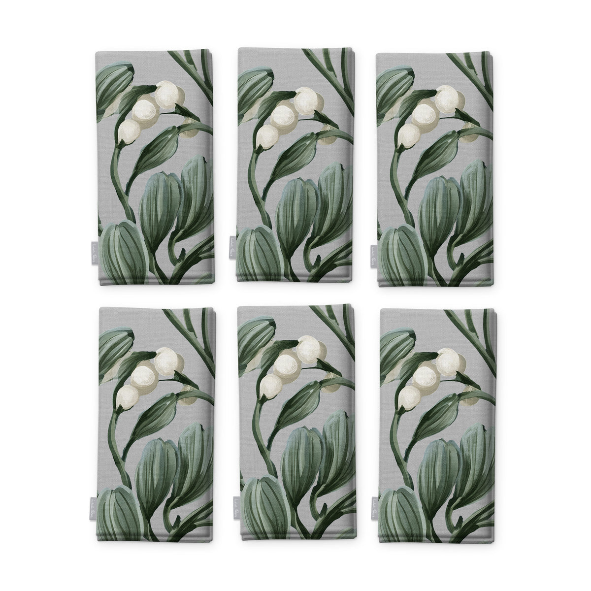 Mistletoe napkins in silver grey, set of six, folded on white, showing the same sprig of mistletoe with white berries