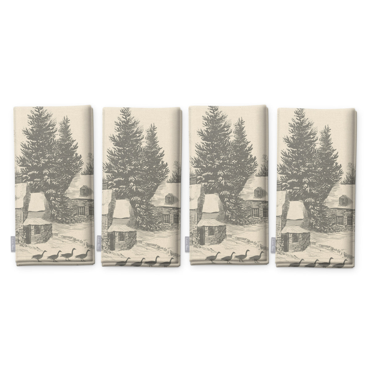 Village Toile napkins in silver grey on ivory, set of four, folded on white, showing the same fir tree and snowy cottage