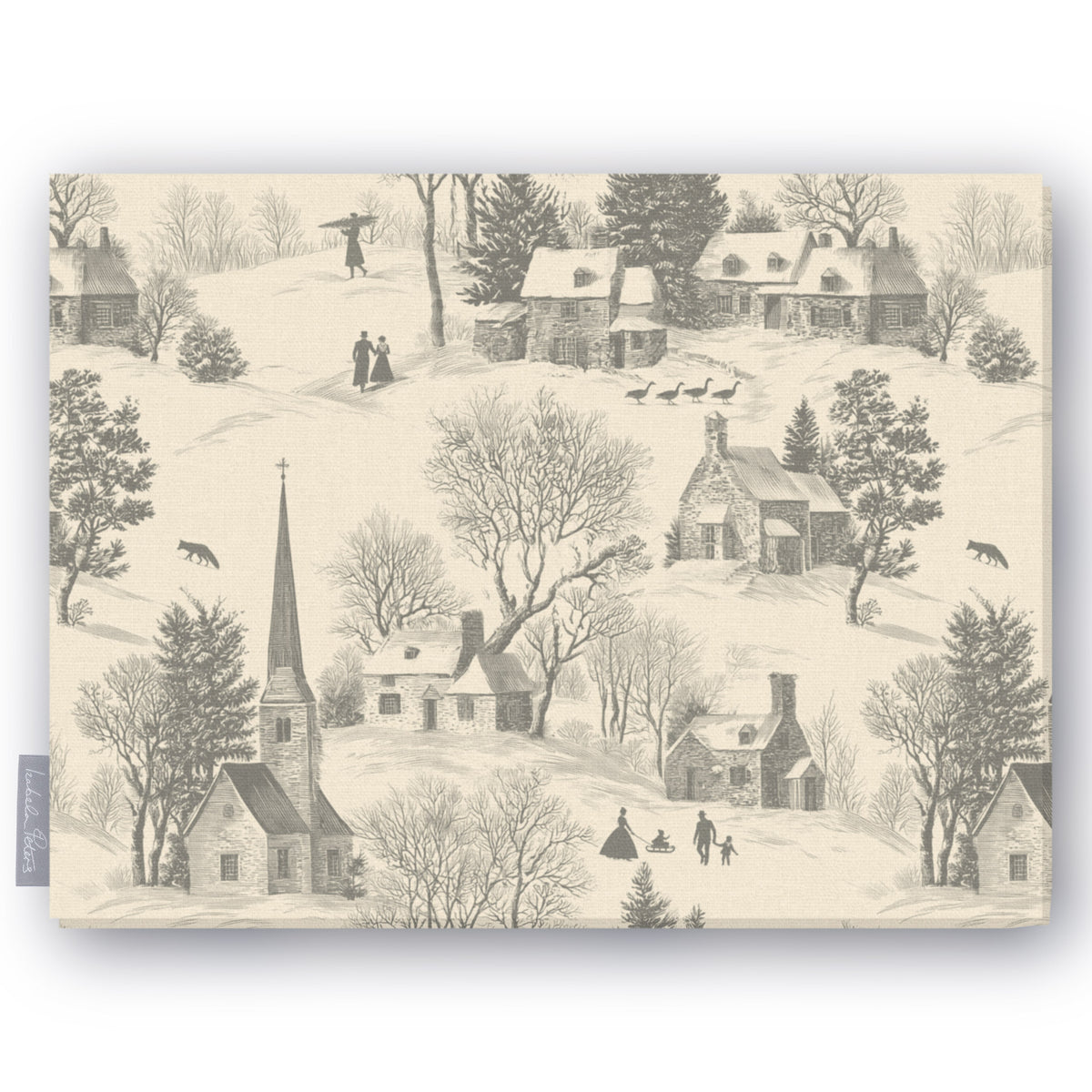 Village Toile tablecloth in silver grey on ivory, folded on white, showing a snowy village with a church and cottages