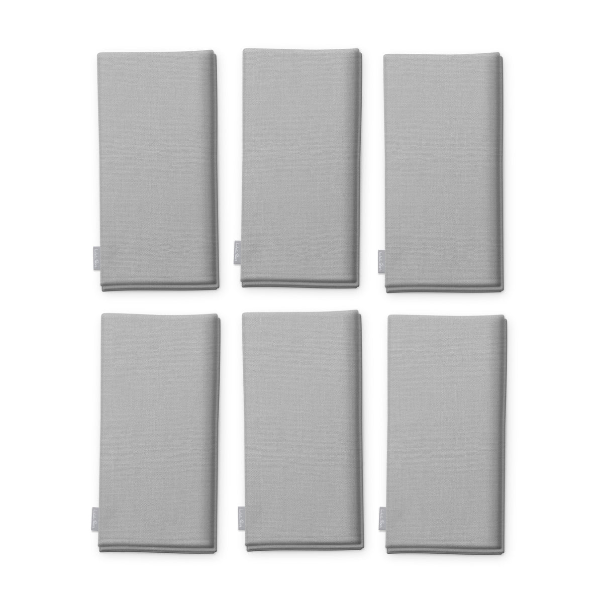 Plain silver cotton Christmas napkins, set of six, folded on white