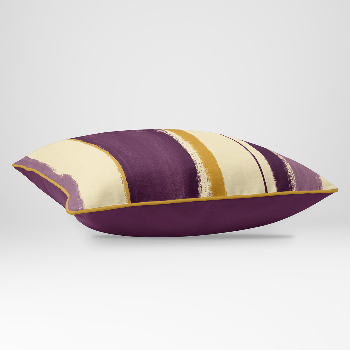 Angled view showing the front and Rich Plum plain reverse of an Unequal Stripe rectangular cushion in Plum & Saffron, finished with Saffron piping.