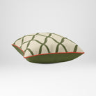 Angled view showing the front and Deep Olive plain reverse of a Palace Trellis square cushion in Olive & Tomato, finished with Tomato piping.