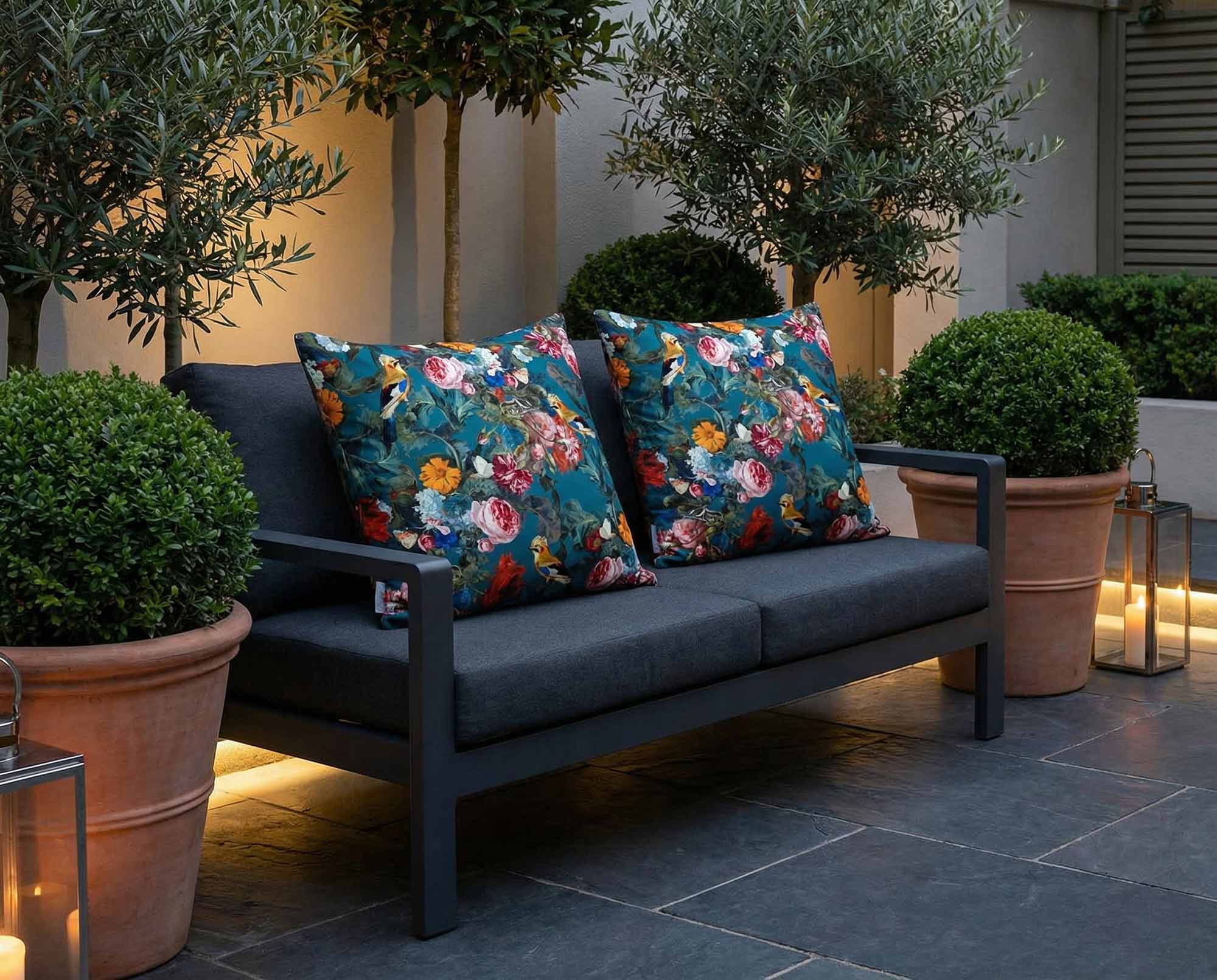Birds outdoor cushions styled on slate patio in a London townhouse garden