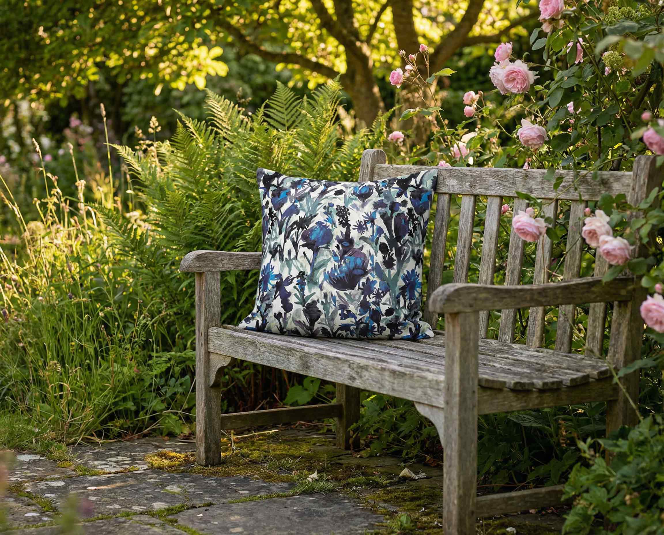 Izabela Peters blue floral outdoor cushion styled on wooden garden bench