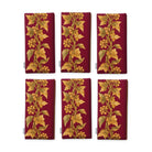 Gilded Ivy Christmas napkins in burgundy and gold, set of six folded napkins showing the same trail of gold ivy and berries