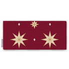 Stars Christmas table runner in burgundy and gold, folded on white, showing large gold eight-pointed stars